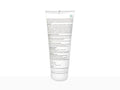 A clear plastic squeeze tube of hair product, shown from the back, featuring dense black text and a small green square logo near the top, set against a plain white background.